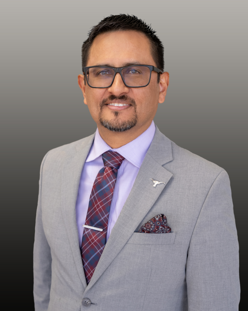 Professional headshot of man in gray suit