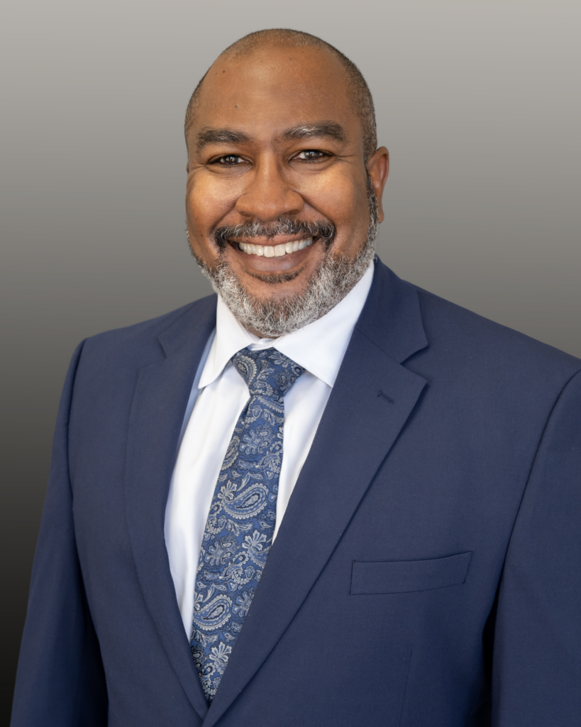 Smiling professional in navy suit and paisley tie