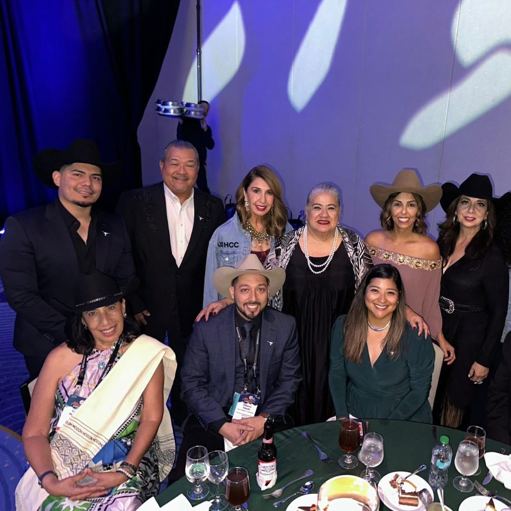 Group of people at dinner wearing cowboy hats