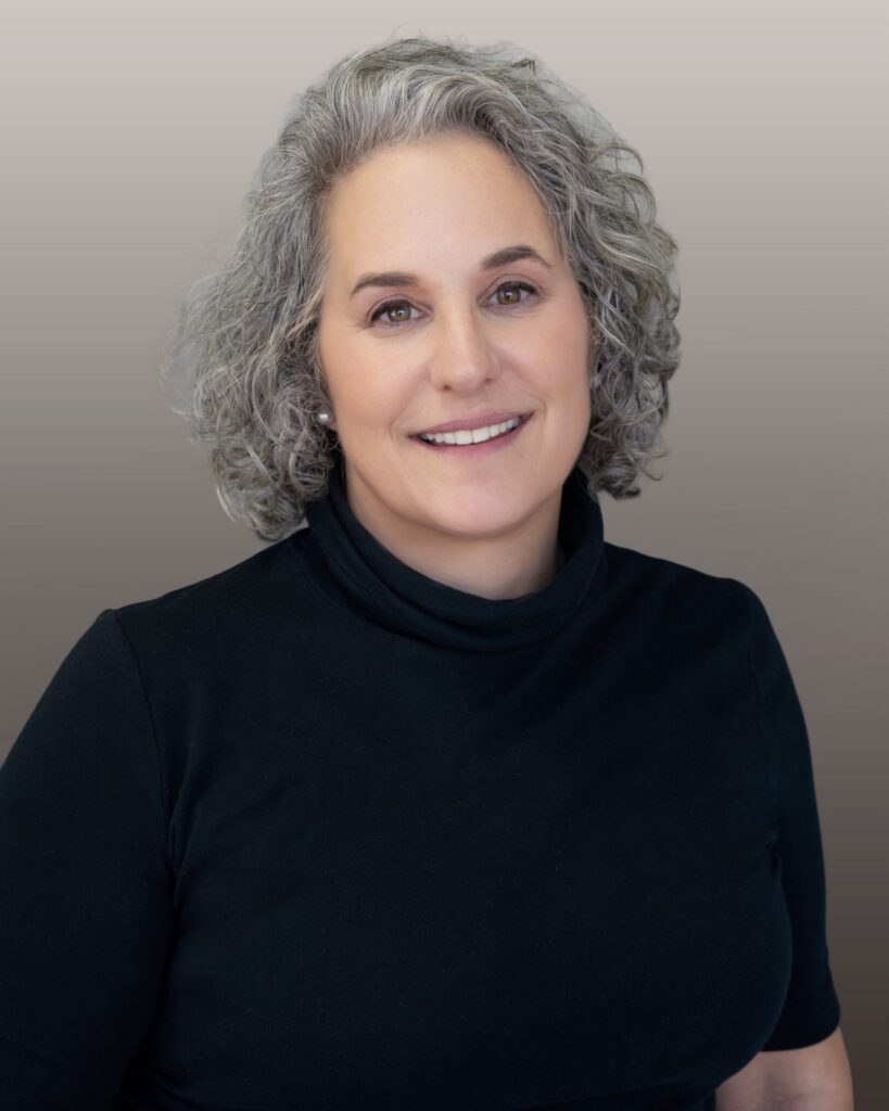 Smiling professional woman with curly gray hair
