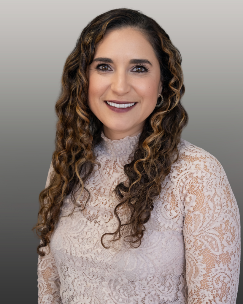 Smiling woman with curly hair headshot