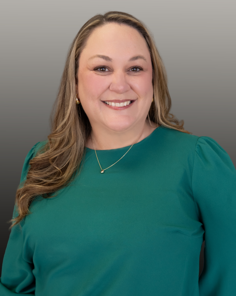 Smiling woman wearing a green blouse