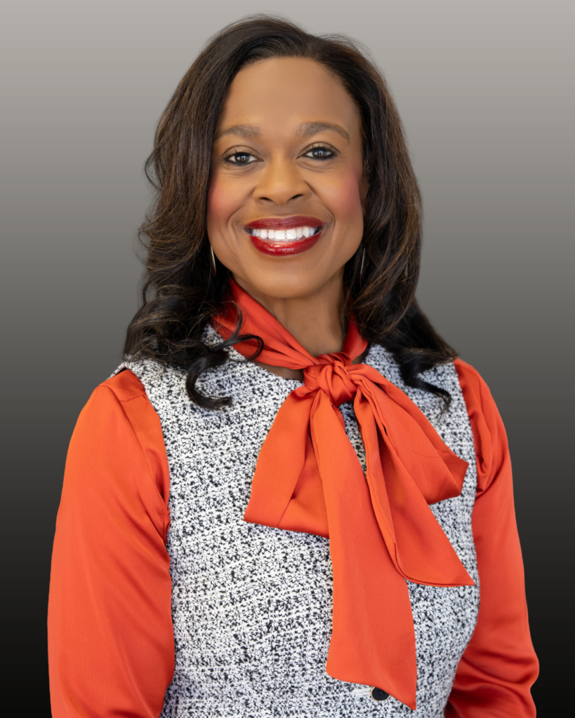 Smiling professional wearing orange bow blouse