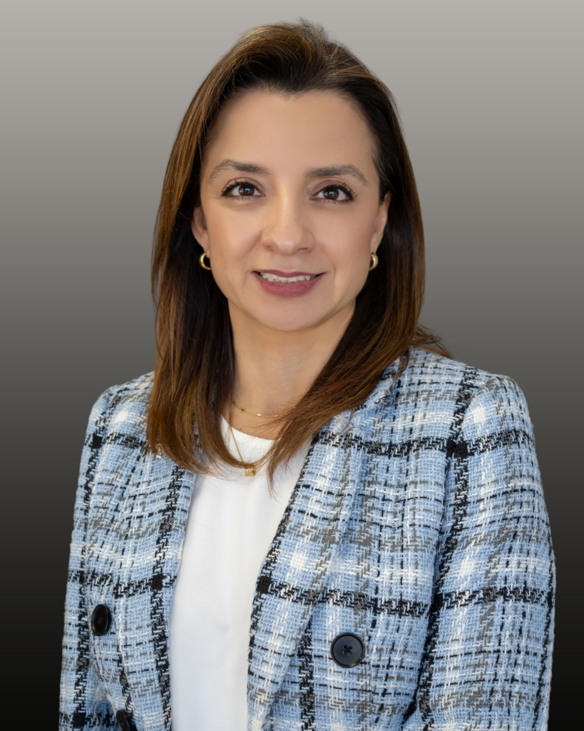 Professional headshot of woman in blue plaid blazer