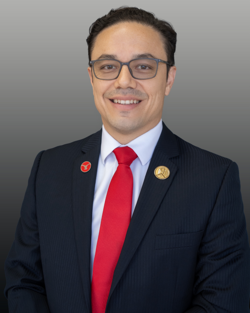 Smiling man wearing suit and red tie