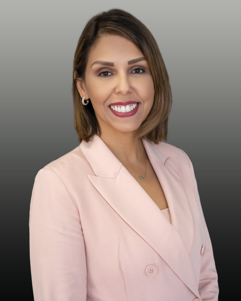 Smiling professional woman in pink blazer