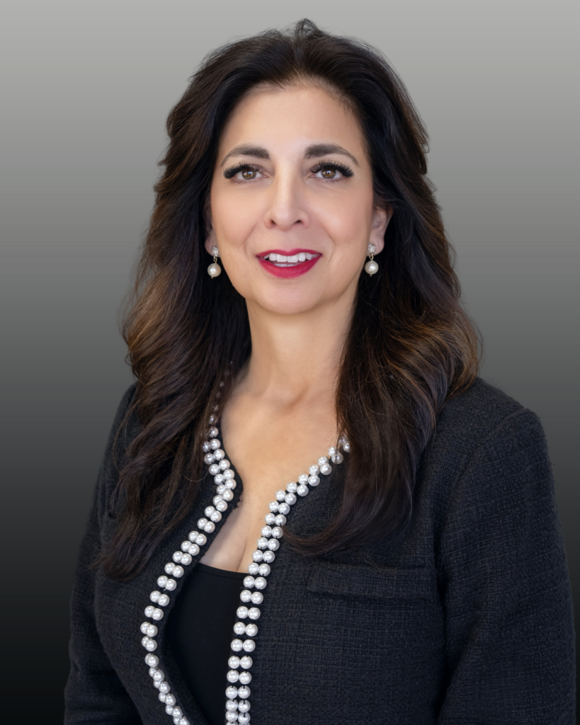 Headshot of woman wearing pearl-trimmed jacket