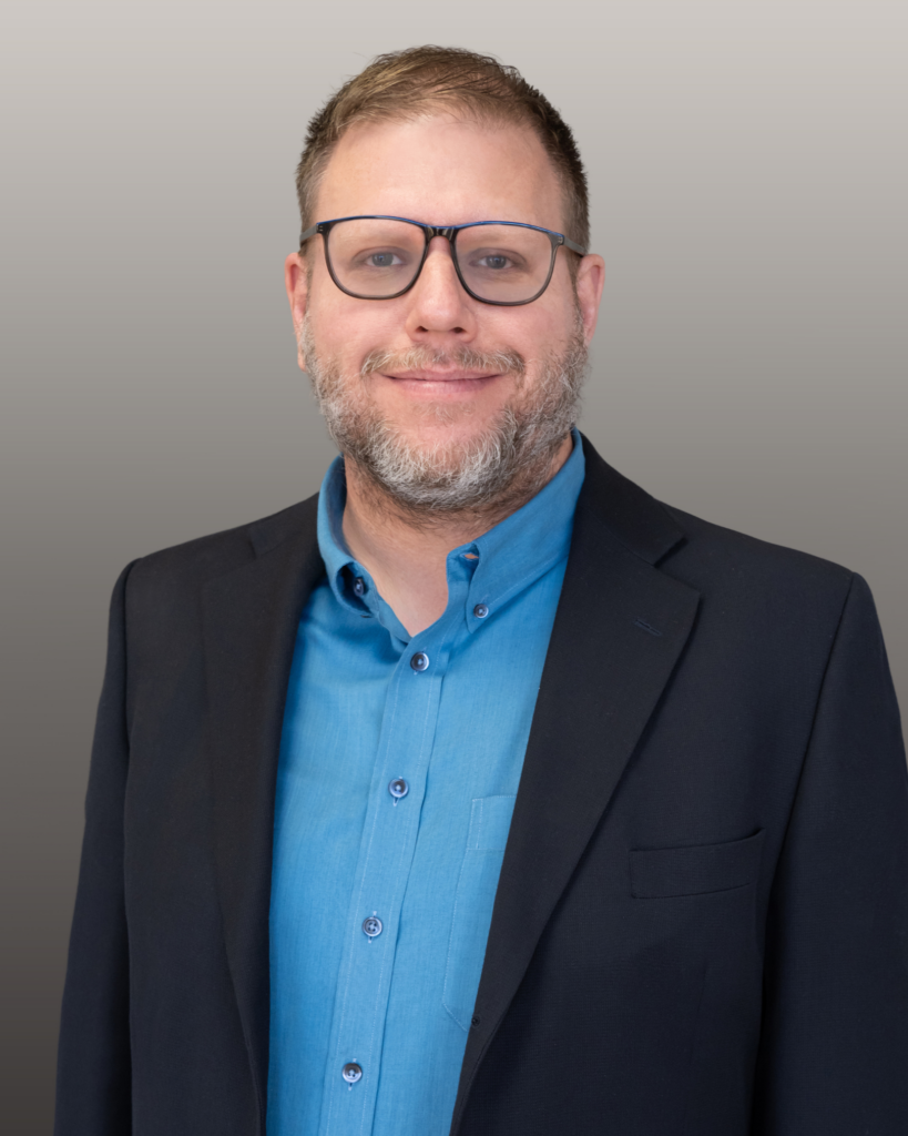 Professional headshot of person with glasses