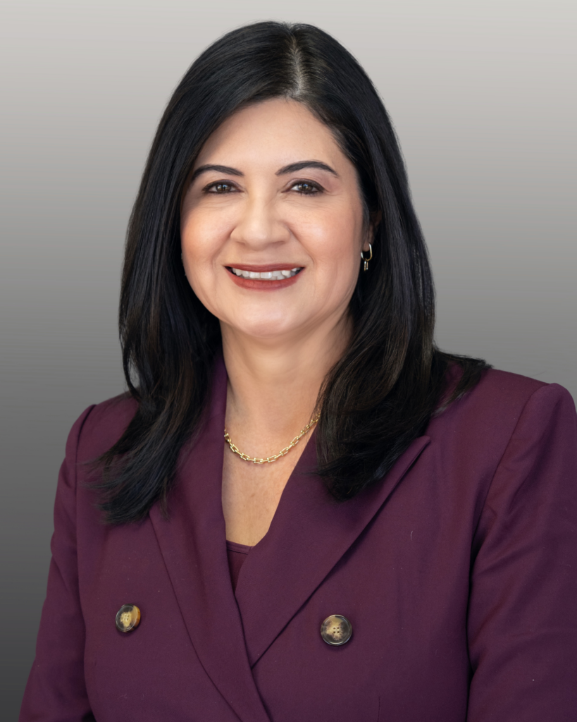Professional woman in maroon blazer smiling