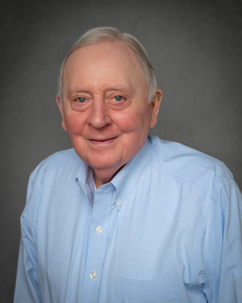 Smiling elderly man in light blue shirt