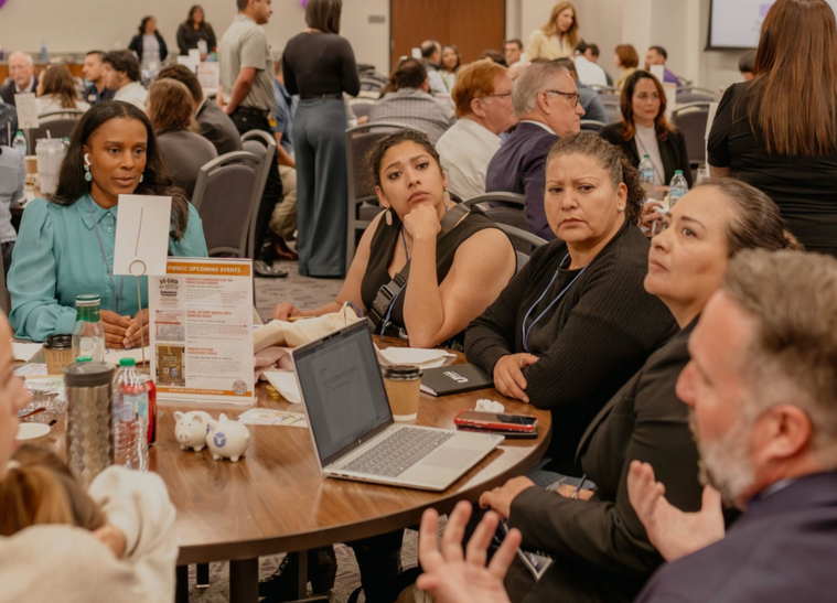 Conference attendees engaged in roundtable discussion