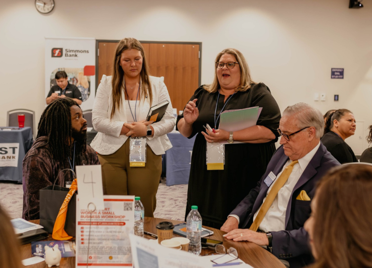 Conference attendees networking around table