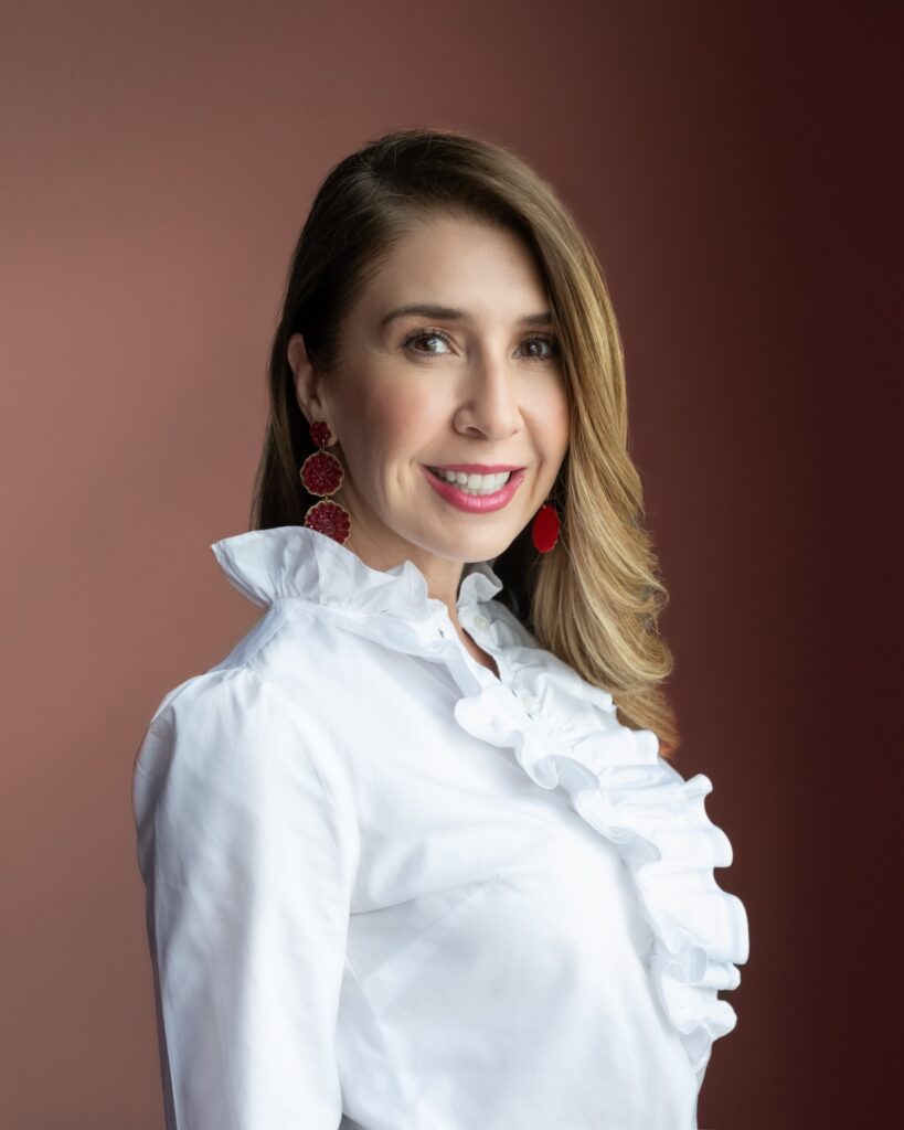 Smiling woman in white ruffled blouse