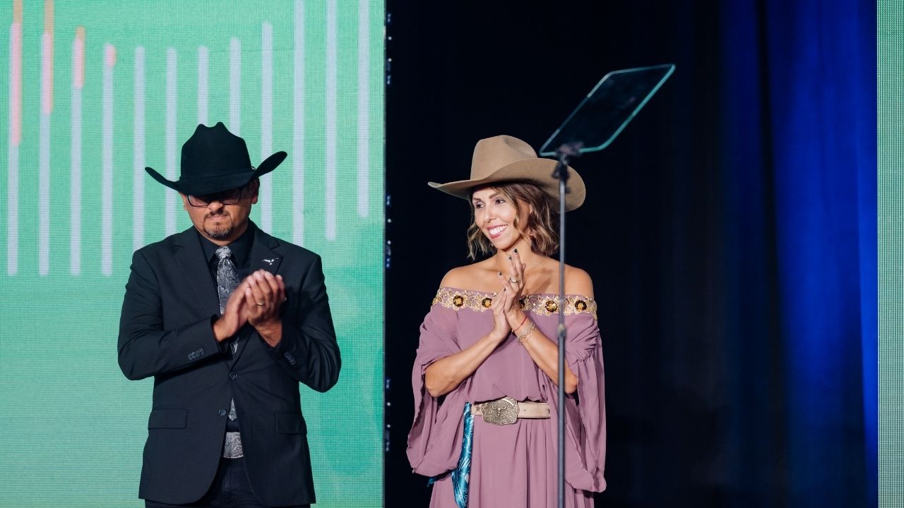 Two people wearing cowboy hats on stage
