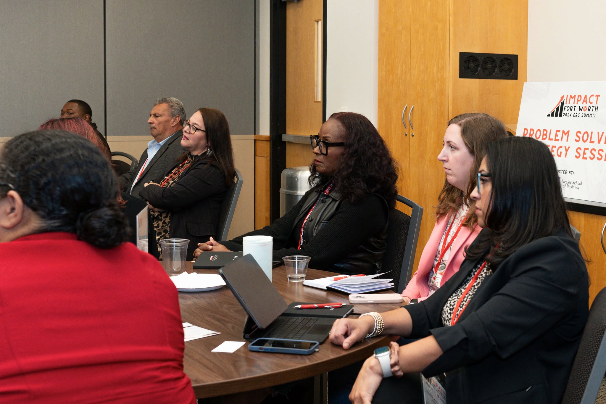 Group of professionals attending meeting around table