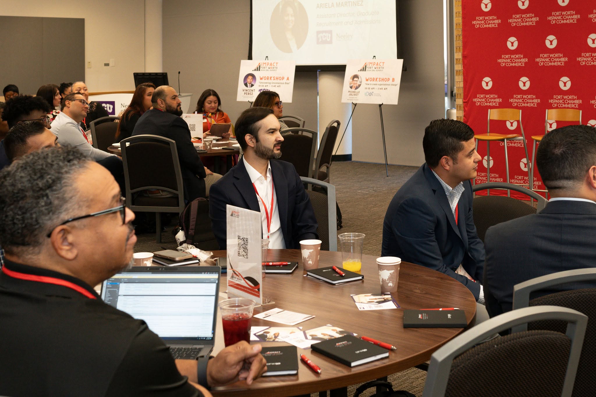 Attendees listening at business conference roundtable