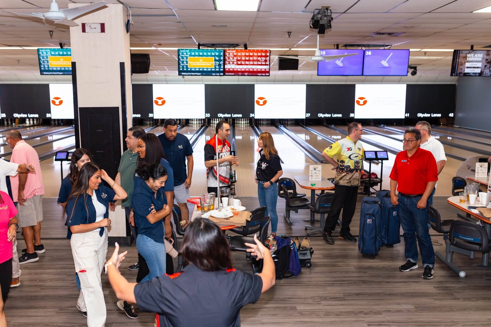 Group of bowlers socializing at bowling lanes