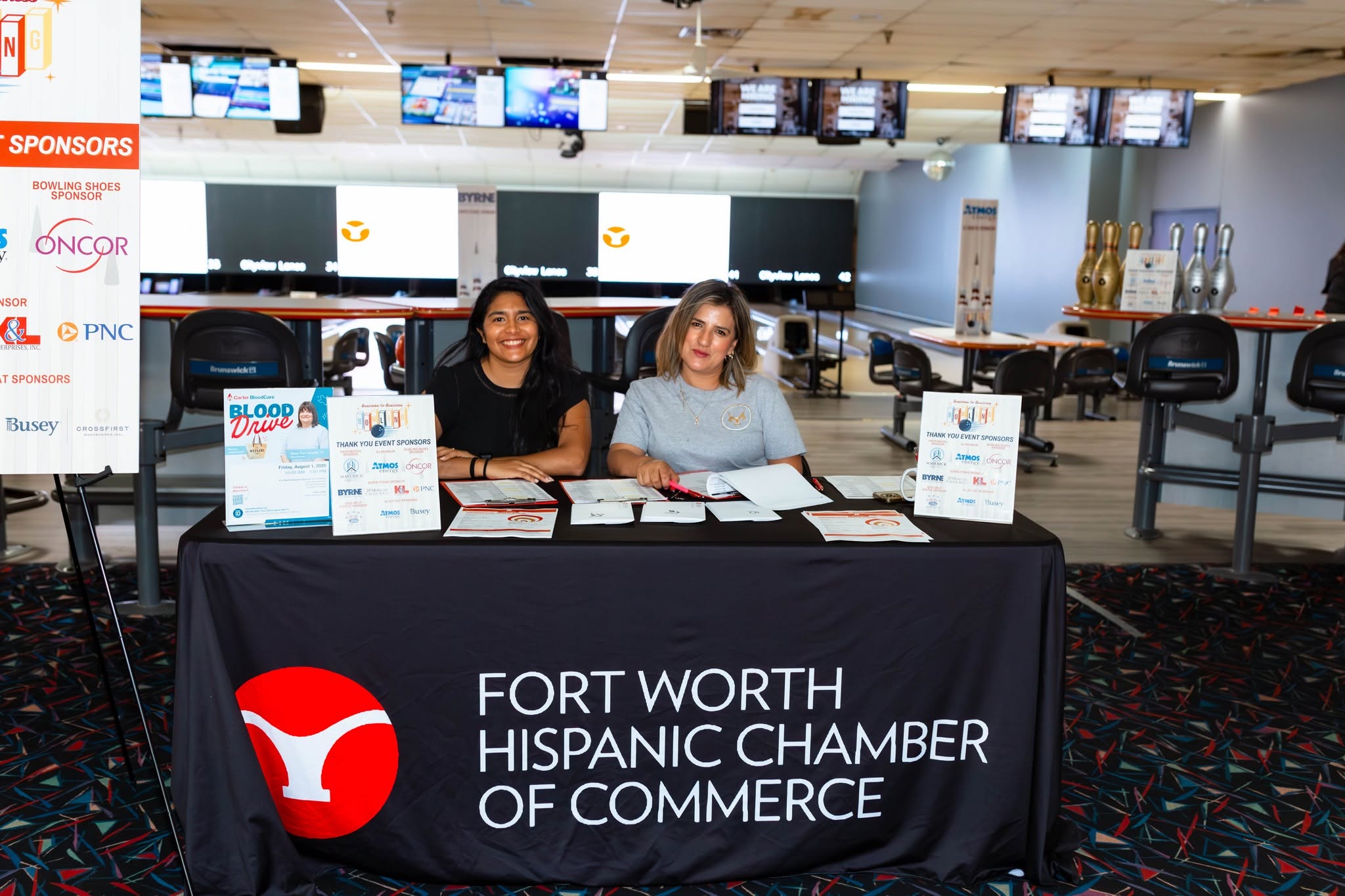 Two women at Fort Worth Hispanic Chamber table