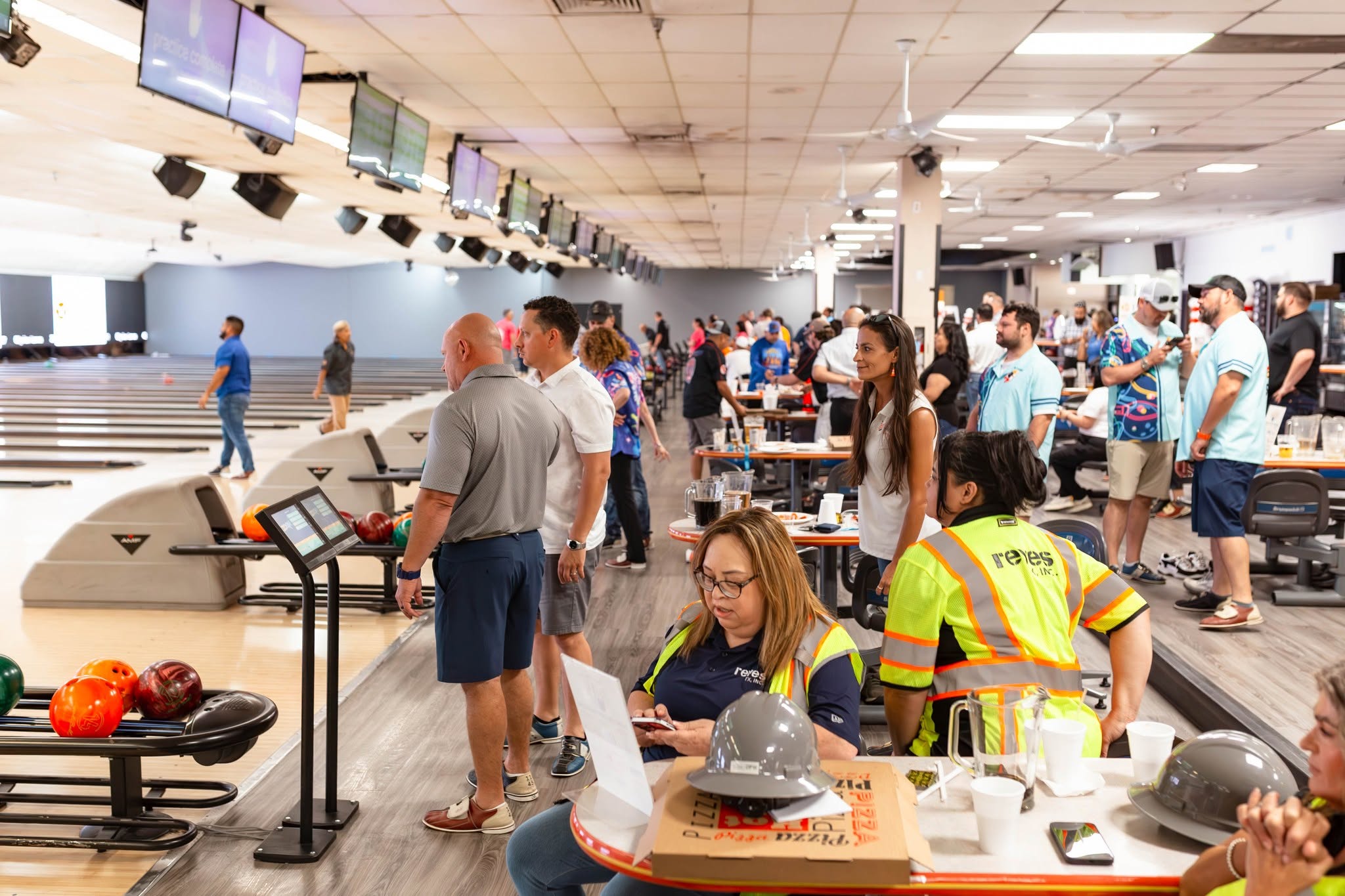 Crowded bowling alley with players and spectators