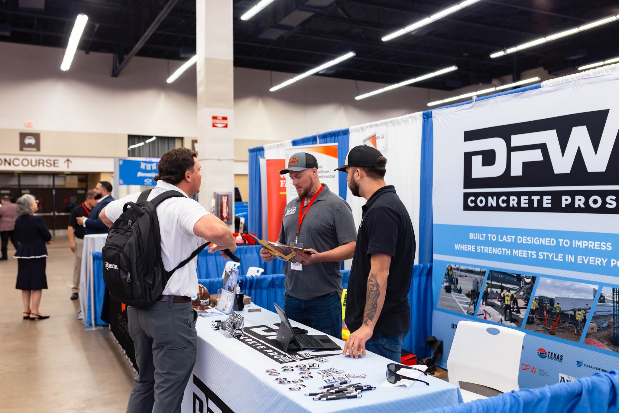 Attendees at DFW Concrete Pros trade show booth