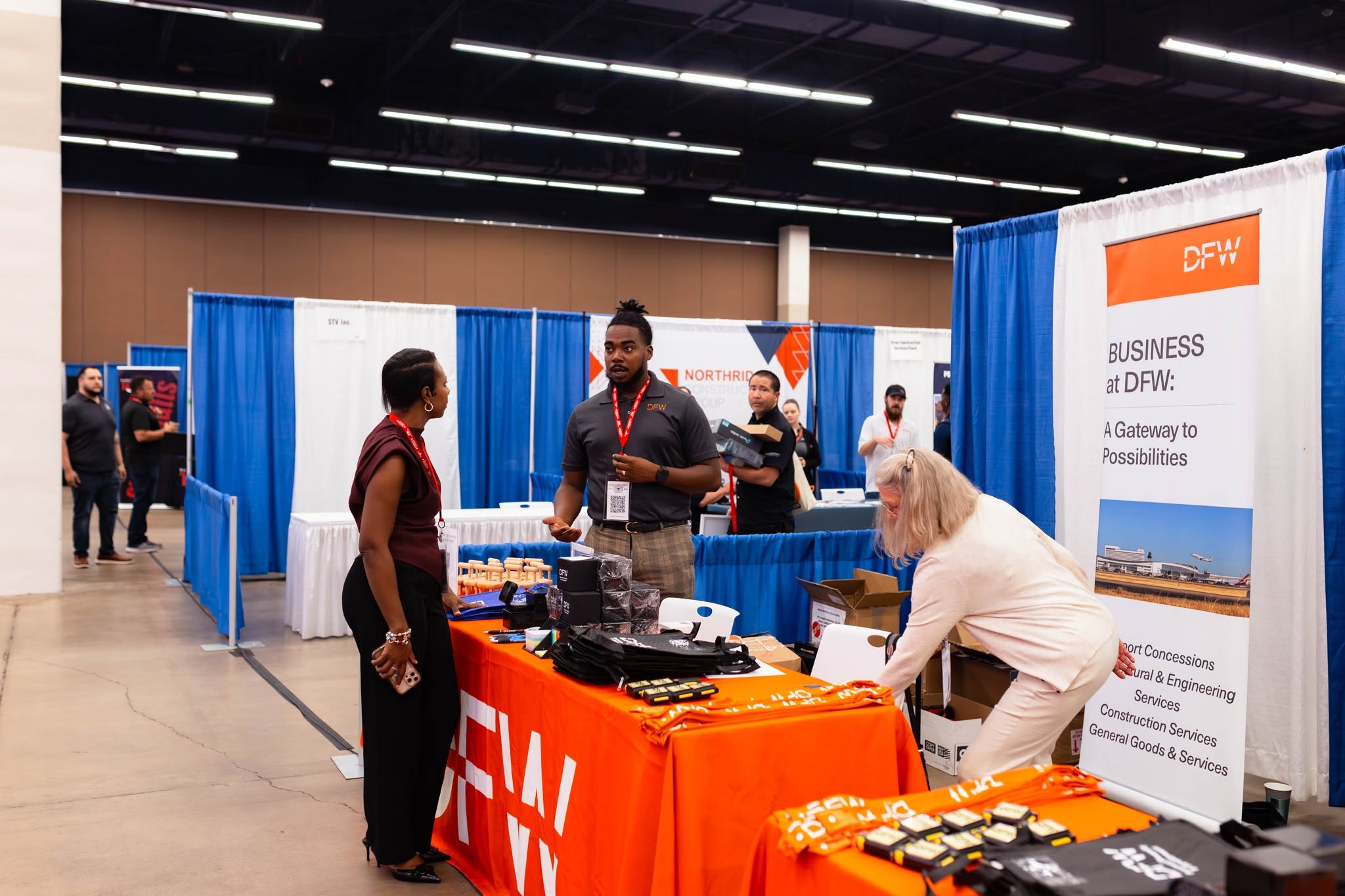 Attendees talking at DFW business expo booth