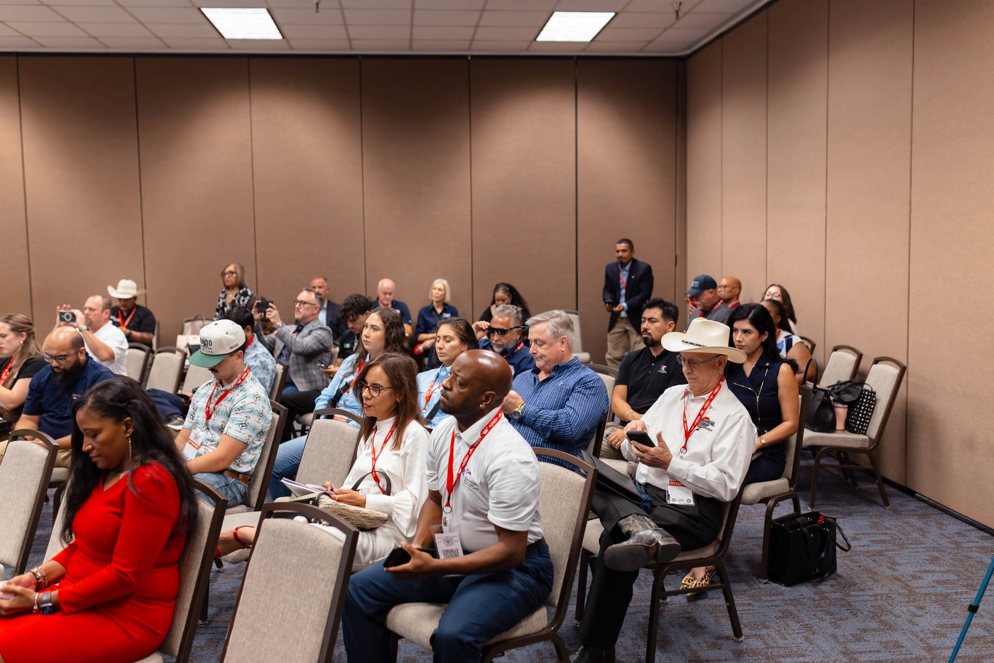 Conference attendees seated in meeting room