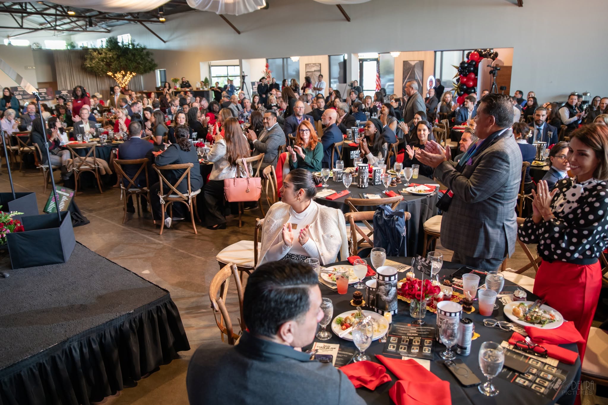 Large audience applauding at indoor banquet event