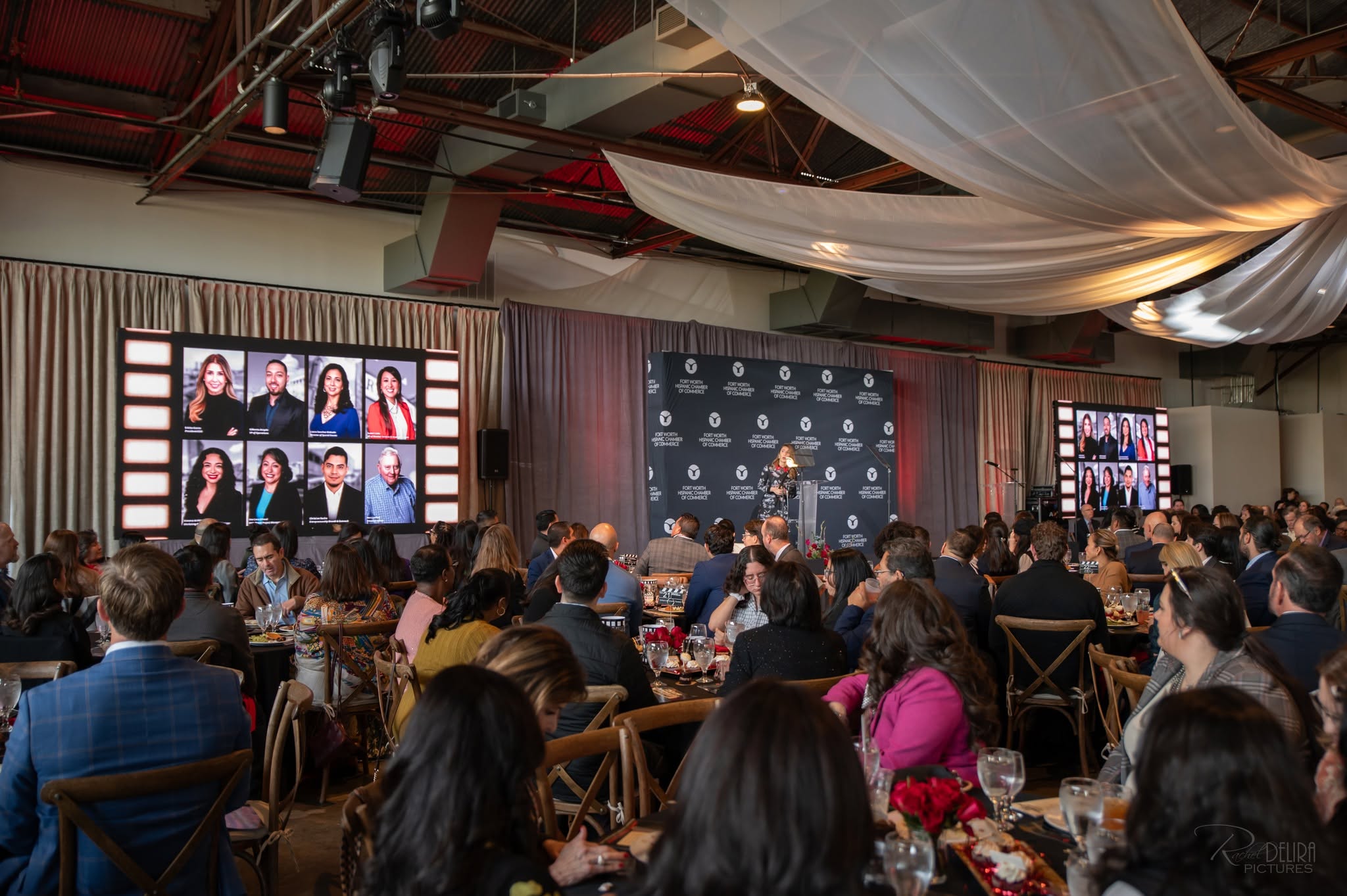 Conference luncheon with speaker and video screens