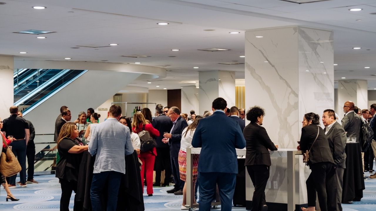 Business professionals networking in hotel lobby