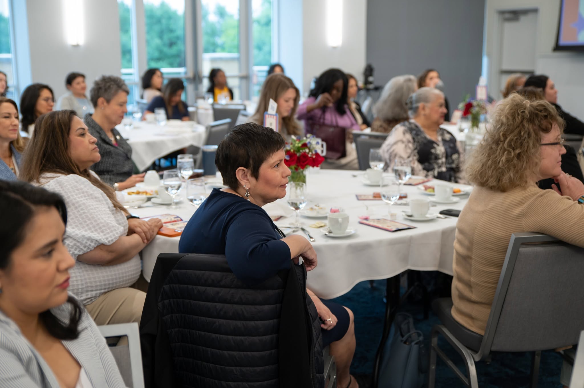 Women seated at conference round tables