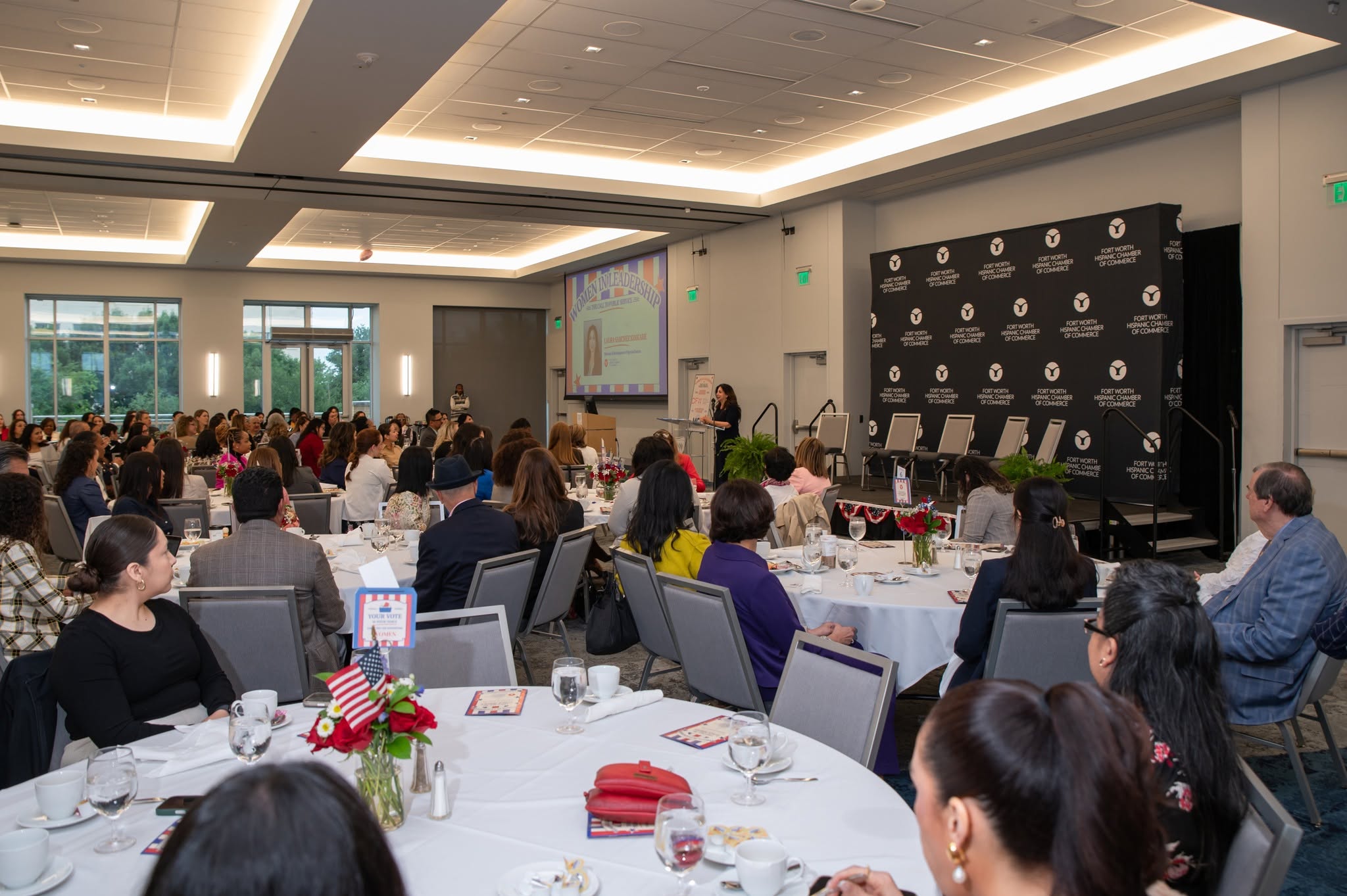 Conference luncheon with speaker and seated attendees