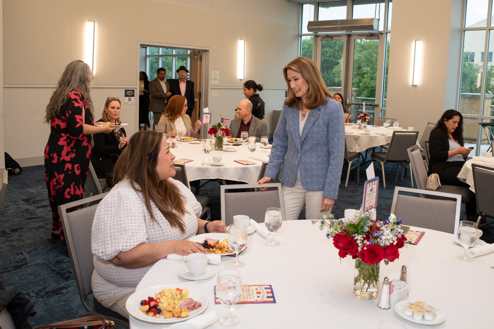 Attendees chatting at seated luncheon event