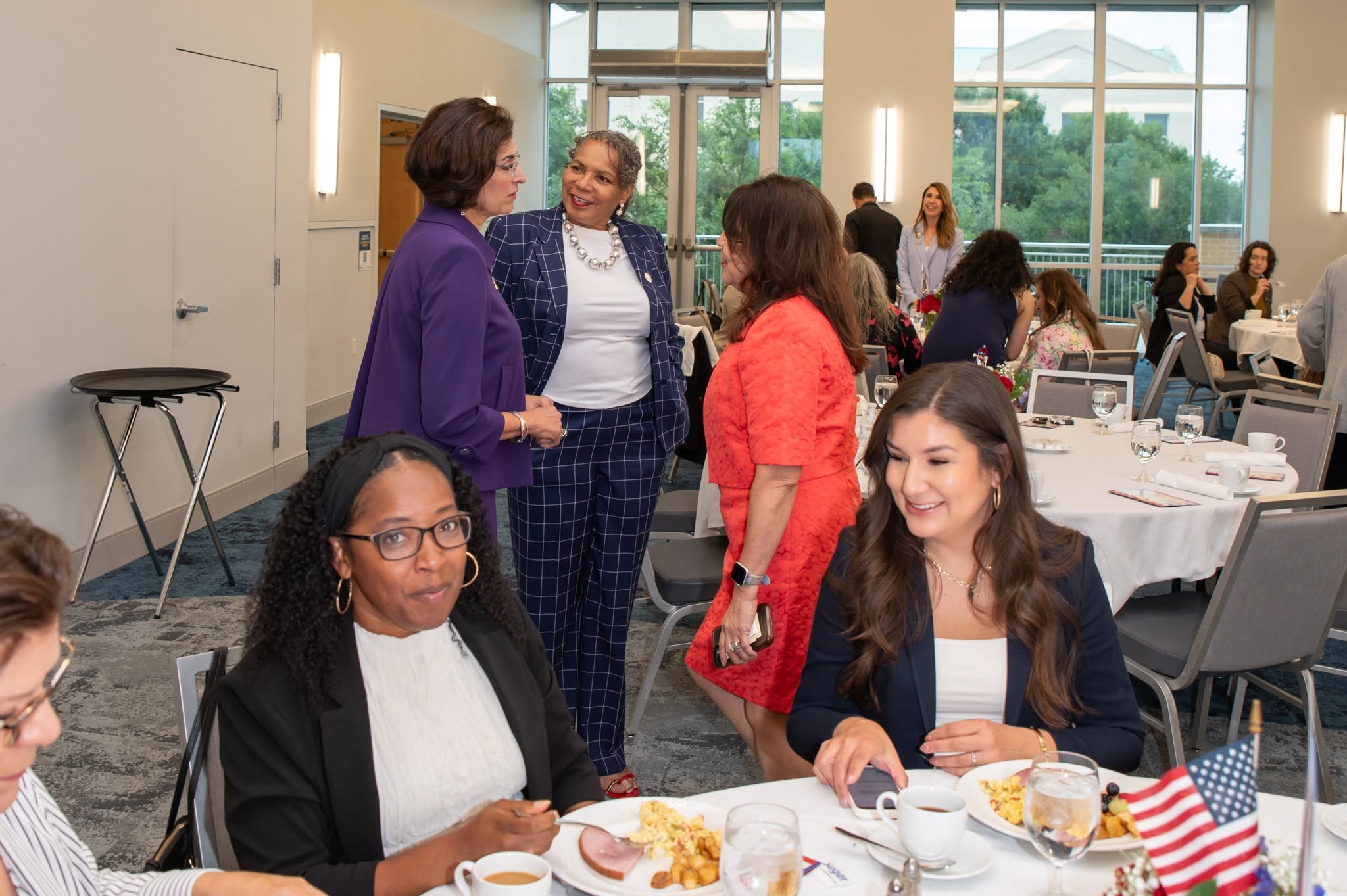 Women networking at luncheon with American flag