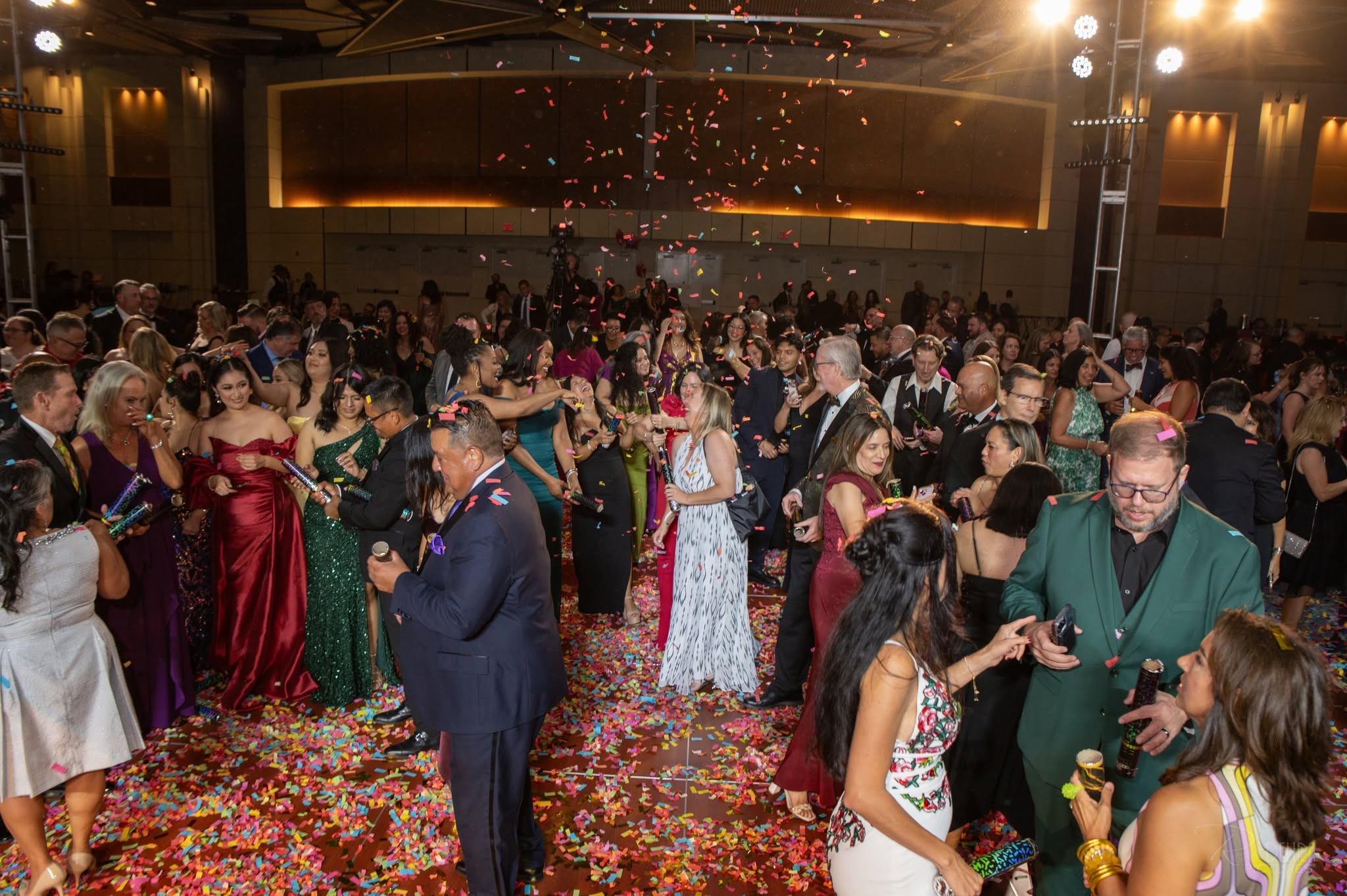 Crowded ballroom gala with confetti and dancing