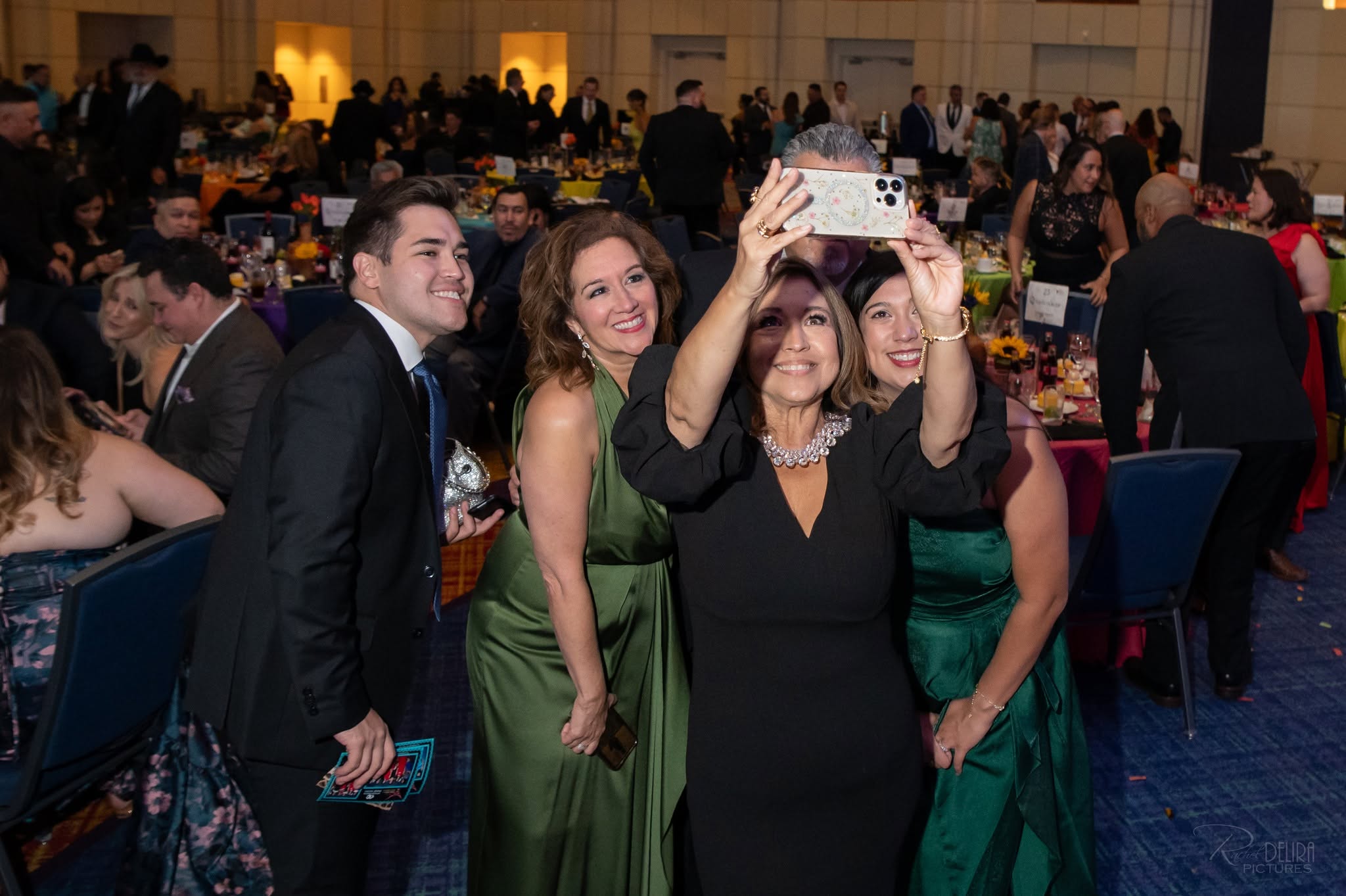 Group taking selfie at formal gala